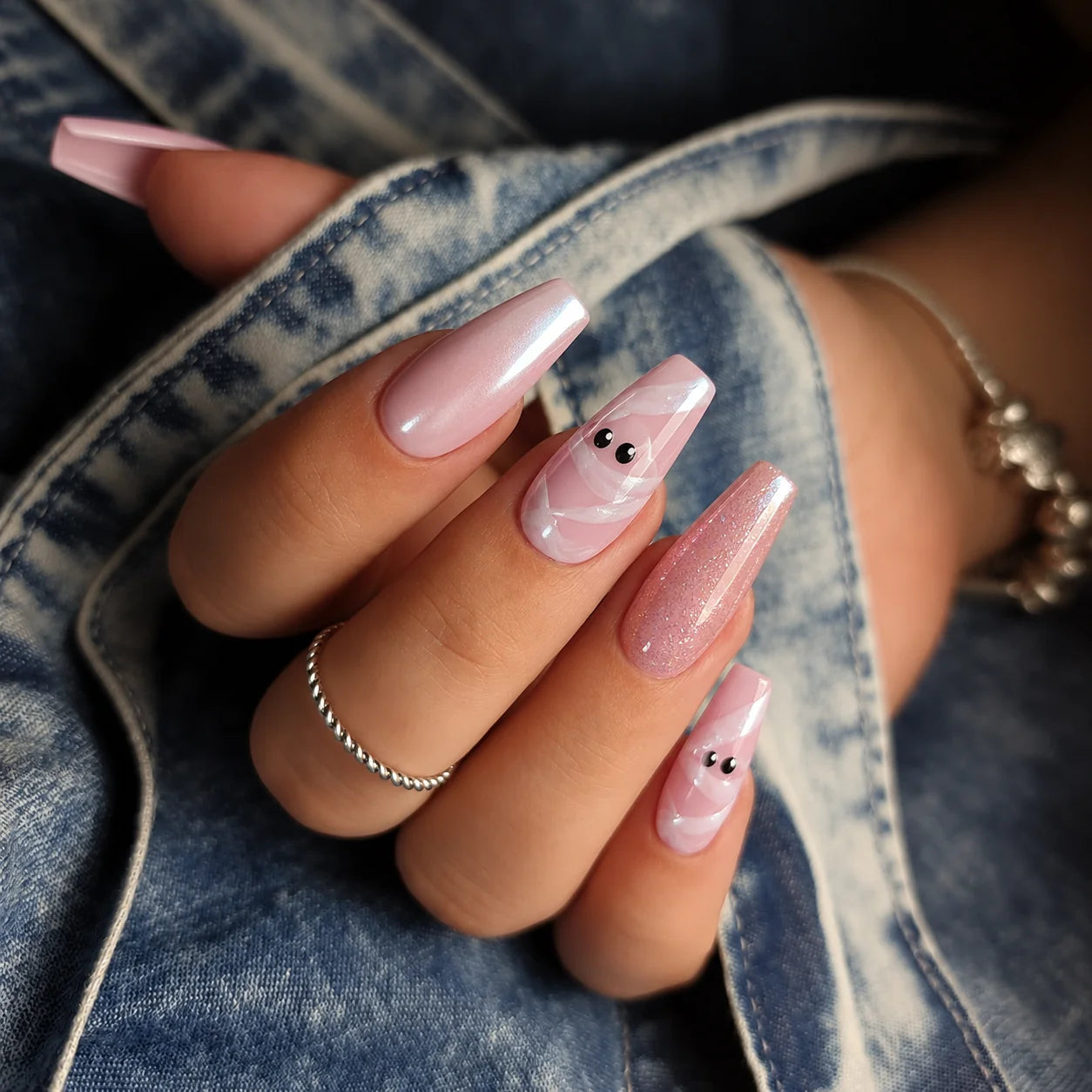 White chrome nails with mummy wrap nail art